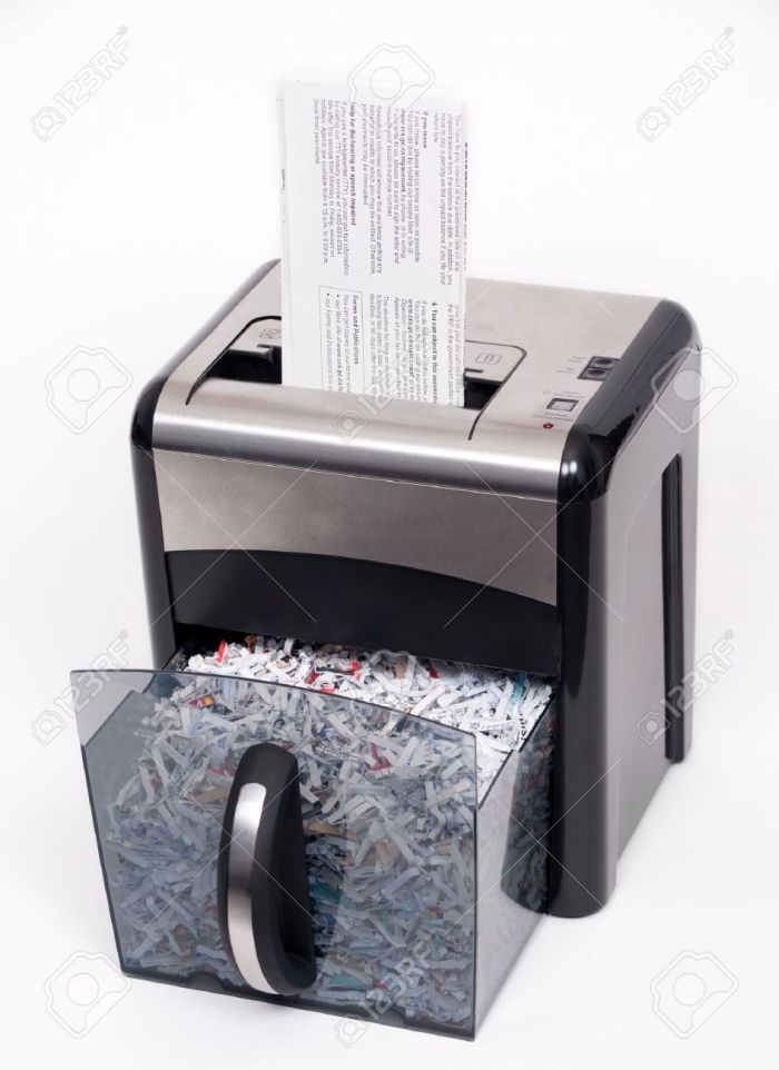 4398536-A-paper-shredder-with-a-confidential-document-about-to-be-shredded-Stock-Photo.jpg